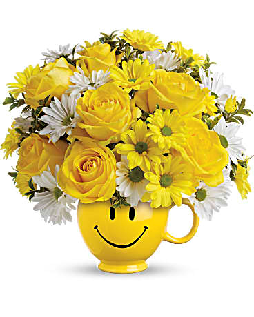 Yellow bouquet in a smiley mug